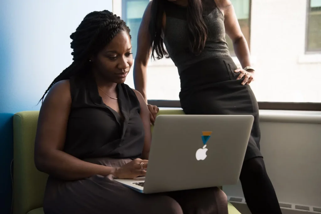 Two female colleagues collaborating on a document on laptop | Computappoint